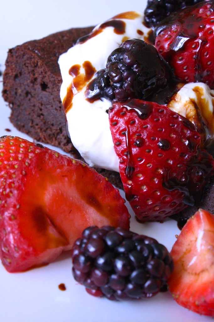 Paleo Flourless chocolate cake with berries, whipped cream and balsamic drizzle
